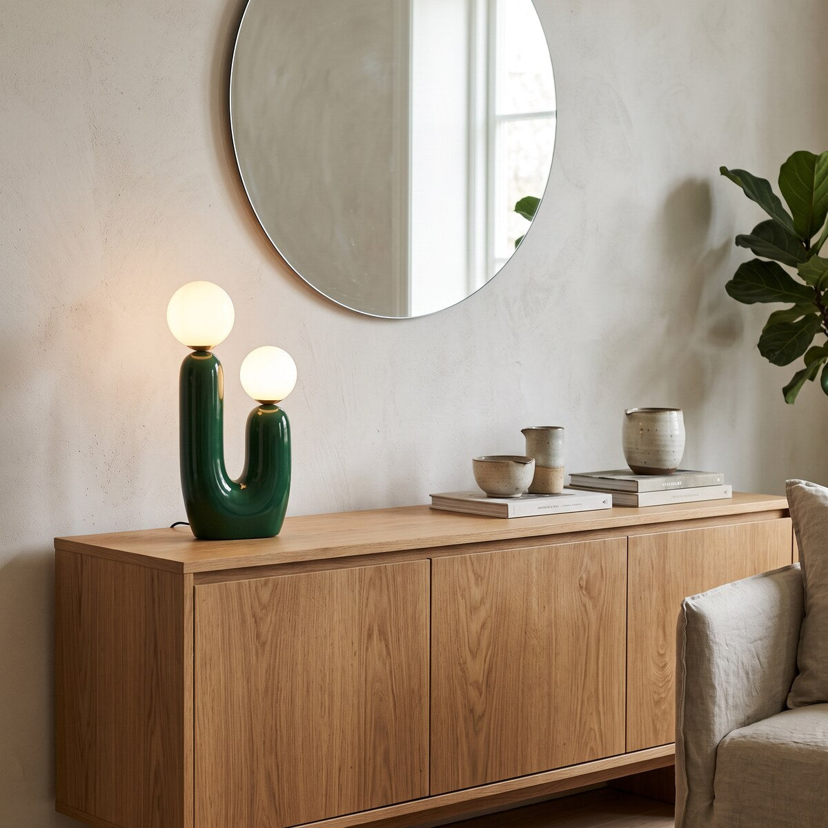 Cacti forest green table lamp on an oak sideboard in a calm living room
