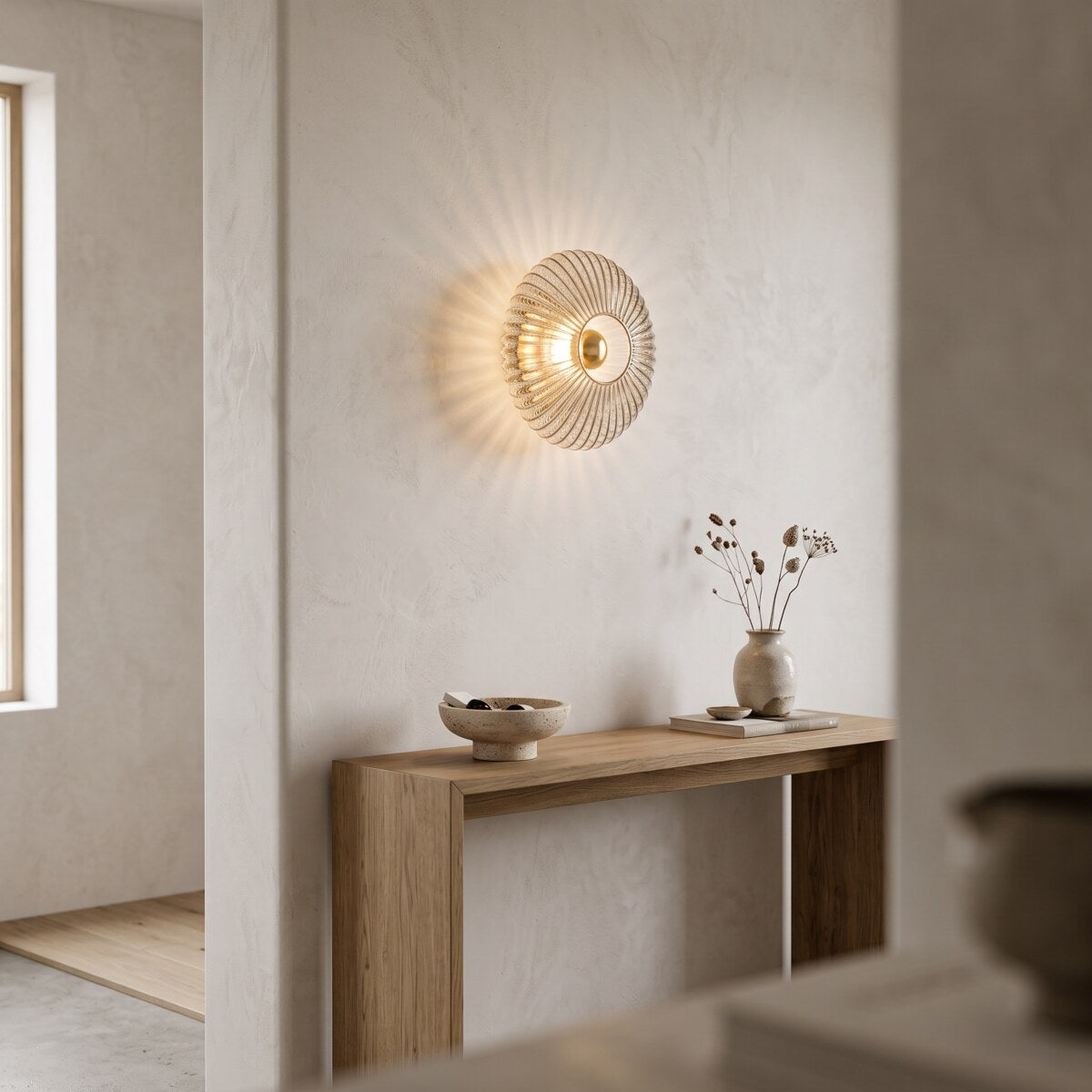 Dahlia smoke grey glass wall light above an oak hallway console