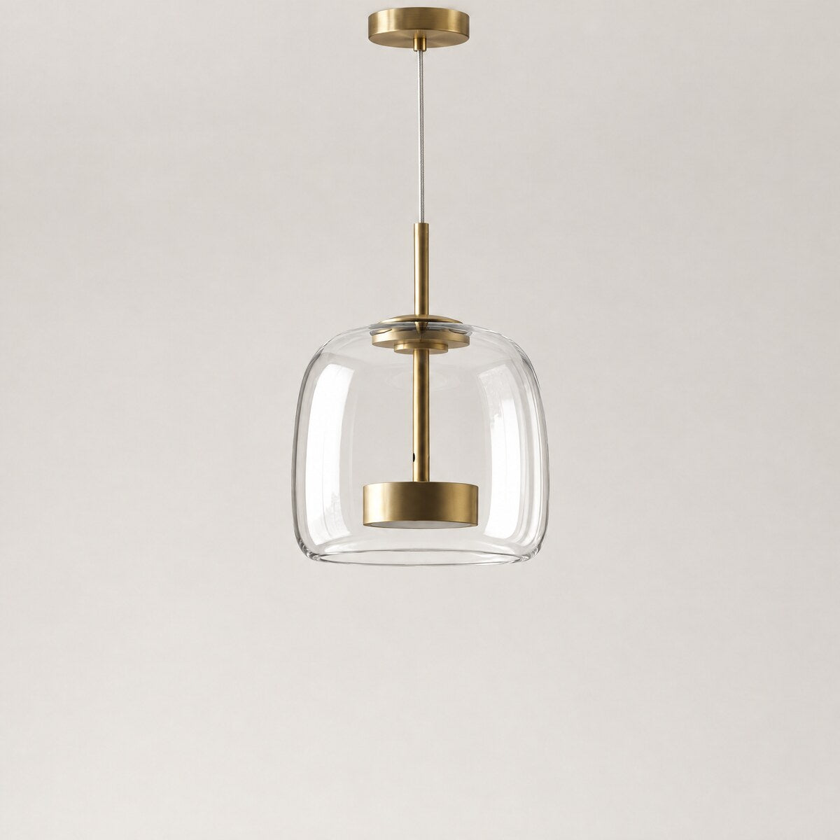Kelda clear glass pendant light with brass LED core