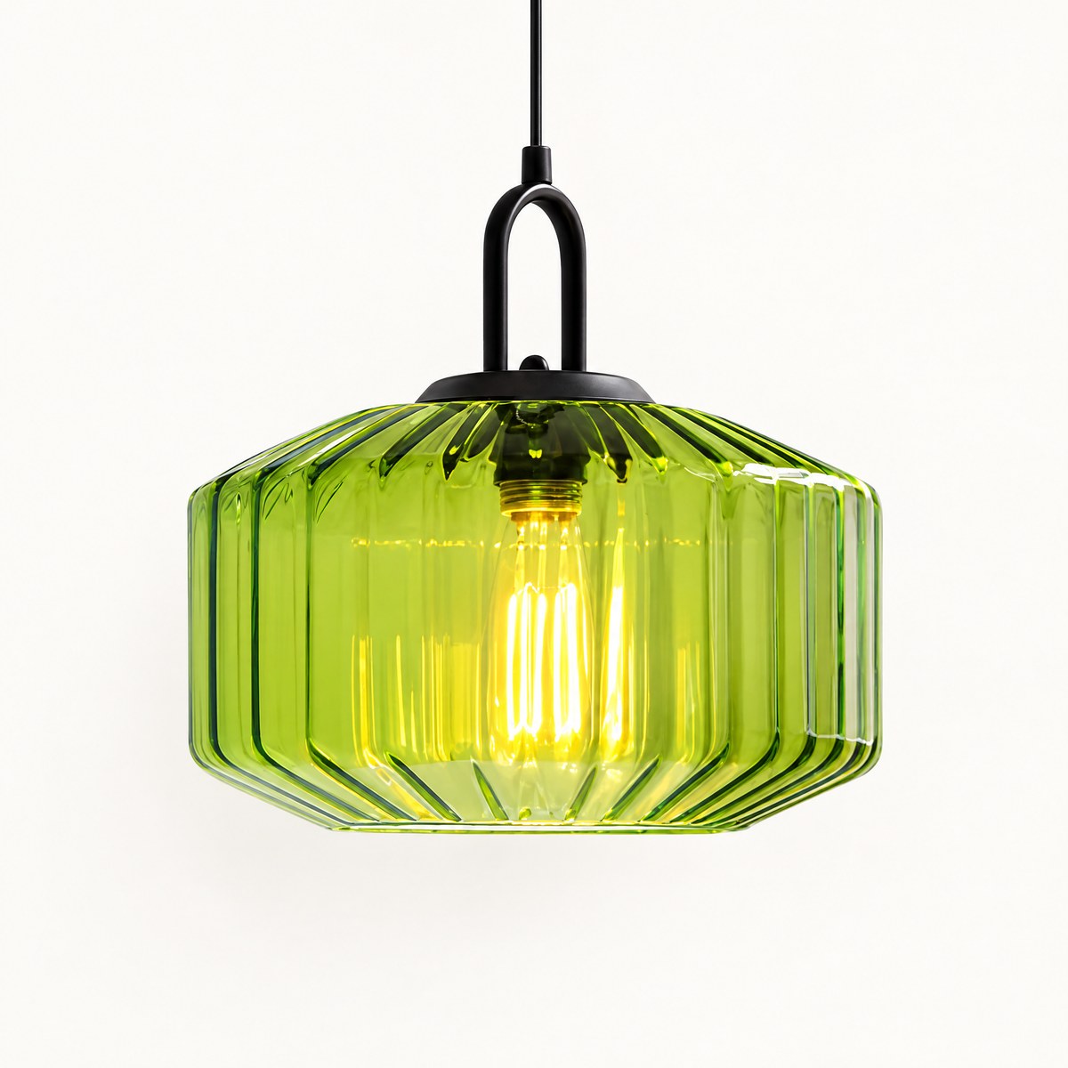 Riva green ribbed glass pendant light with filament bulb, lit, on white background