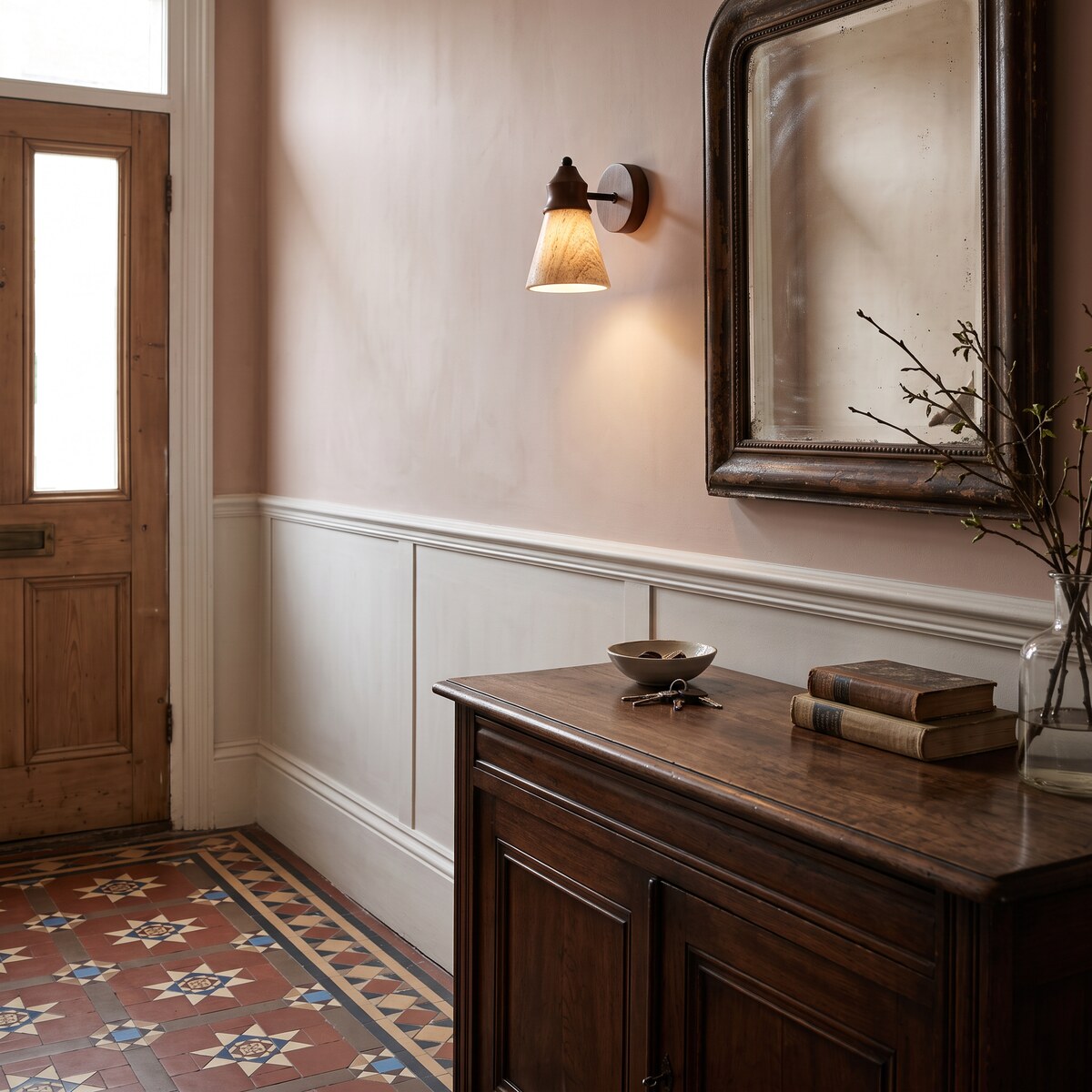 Tufa travertine wall light in a plaster-pink period hallway with tiled floor