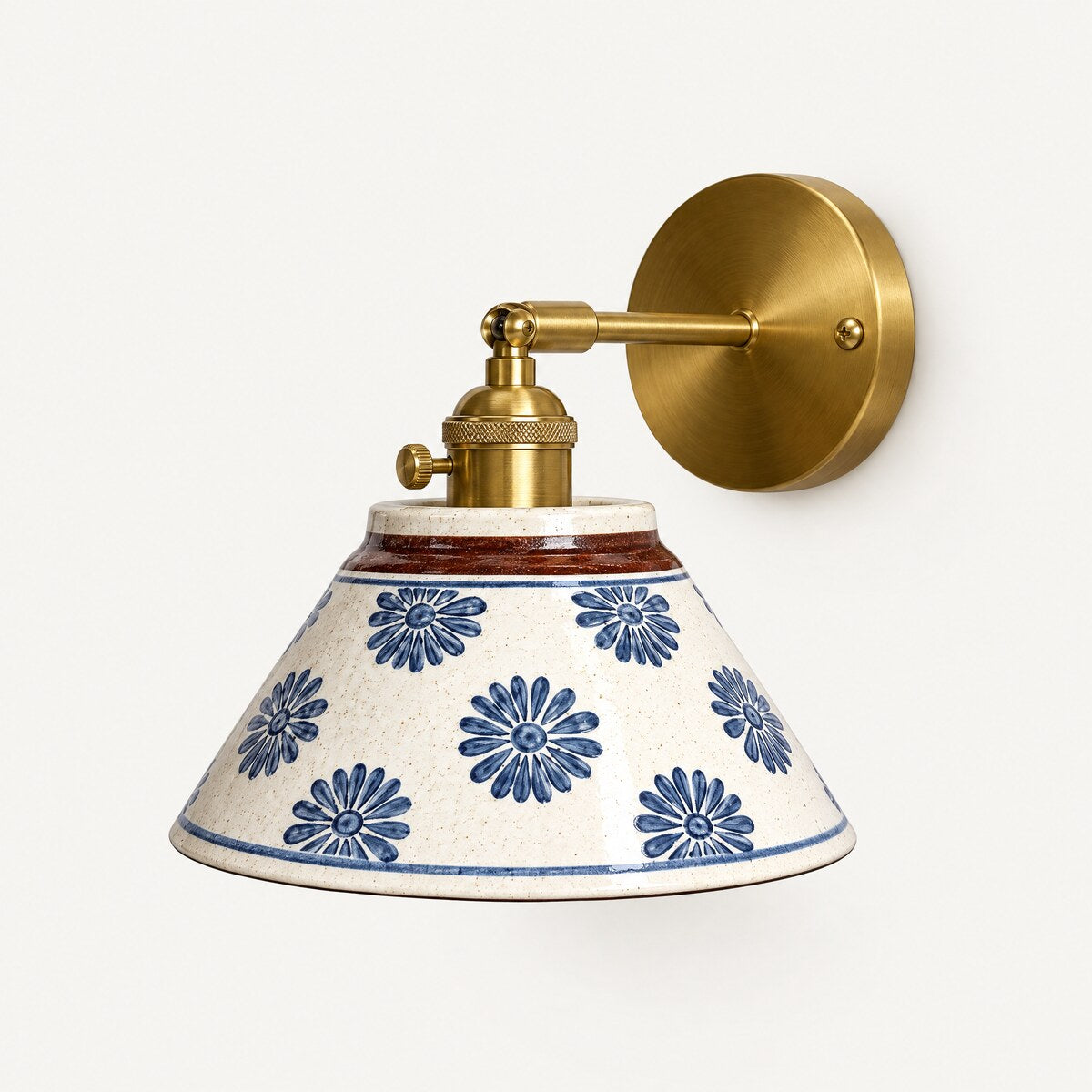 Birk hand-painted ceramic wall light in Blue Daisy with brushed brass arm