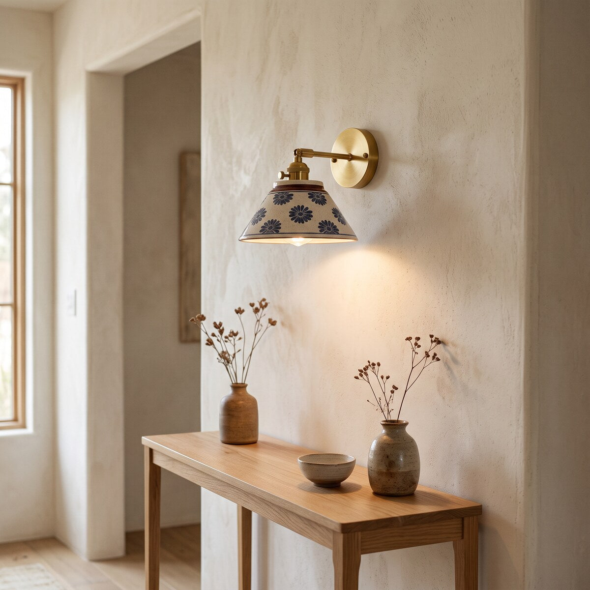 Birk ceramic wall light in Blue Daisy lighting an oak hallway console