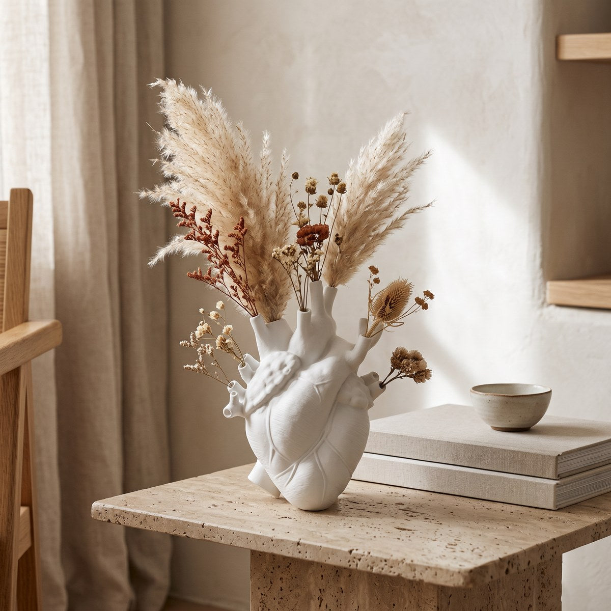 Cuore white anatomical heart vase with dried pampas grass on an oak shelf