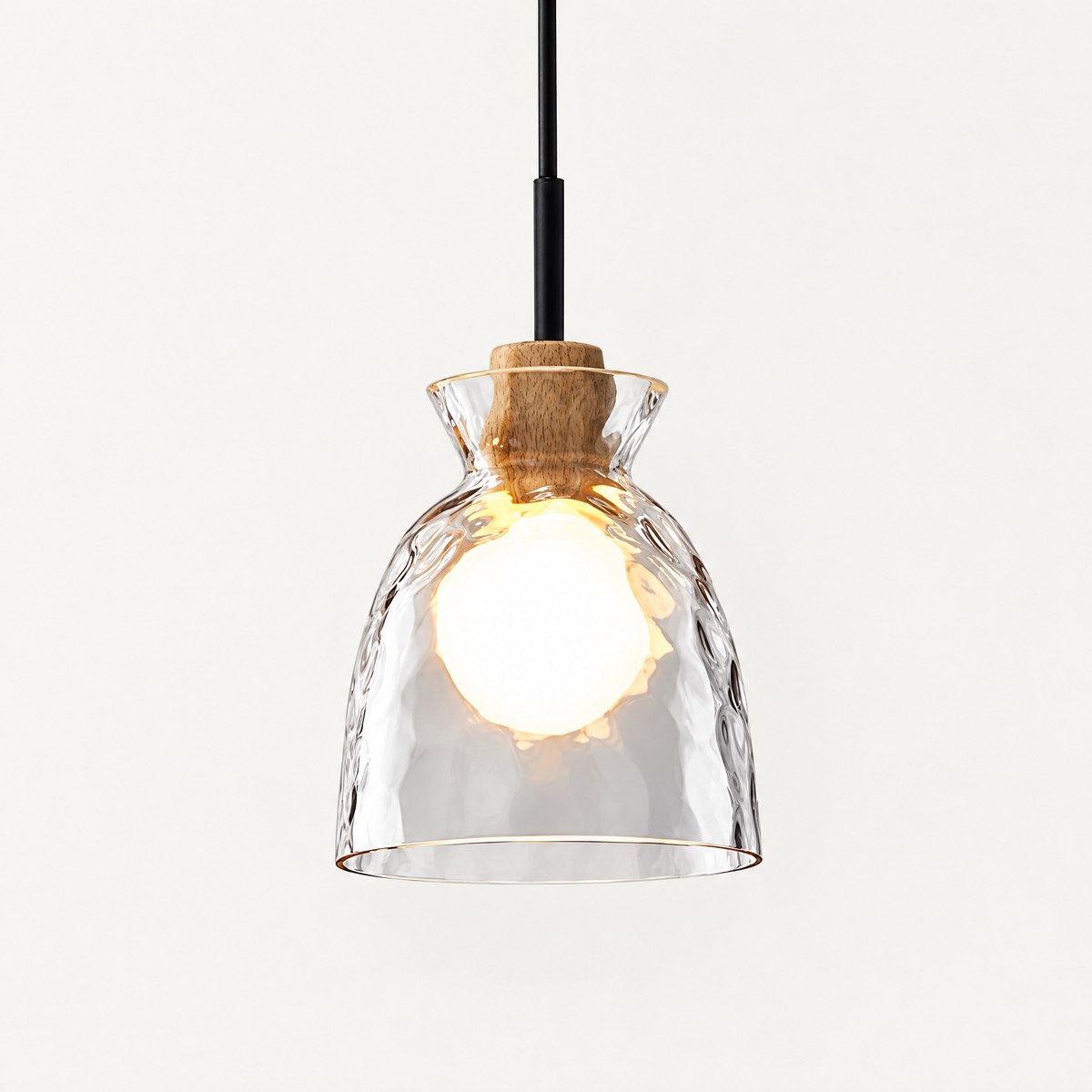 Fjord rippled glass bell pendant light with natural wood cap, lit, on white background