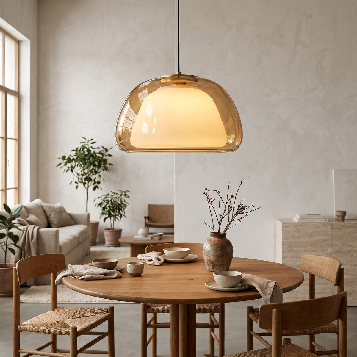 Nimbo amber double glass dome pendant light, 39cm, over a round oak dining table