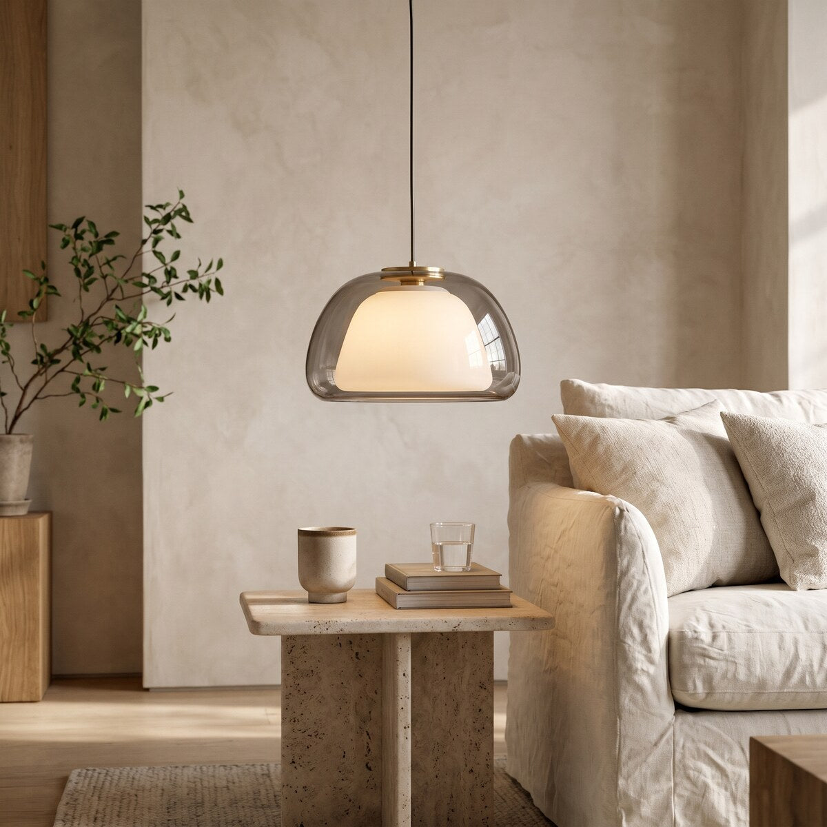 Nimbo smoke grey double glass dome pendant light, 25cm, beside a linen sofa