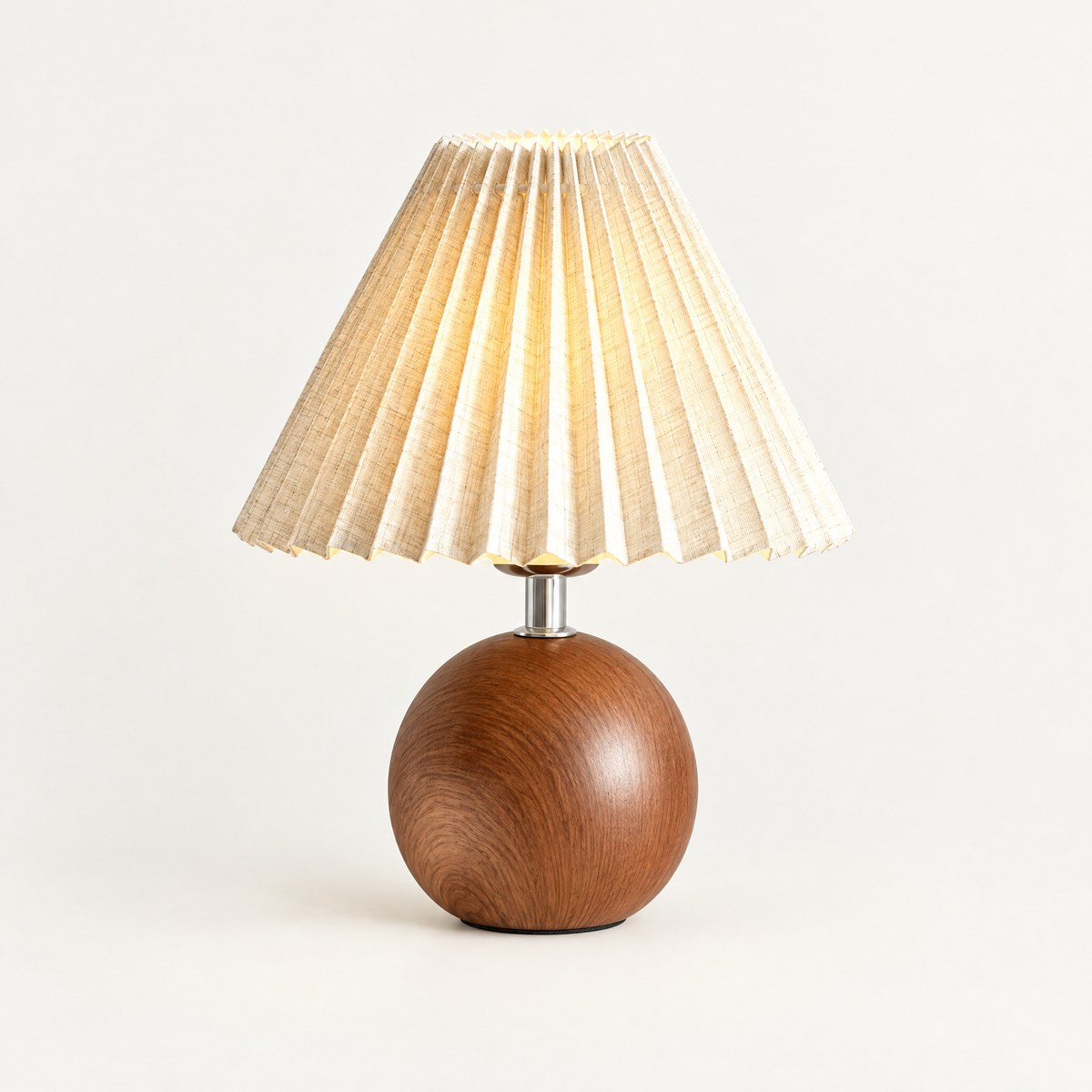 Plisa pleated table lamp with wood-effect globe base, lit, on white background