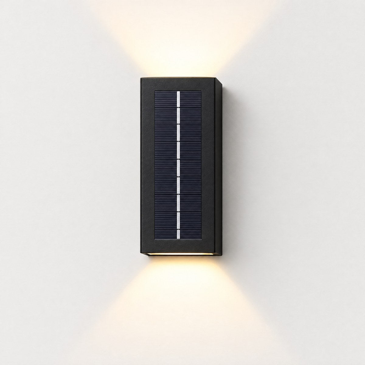 Solano black solar up and down outdoor wall light on an off-white wall