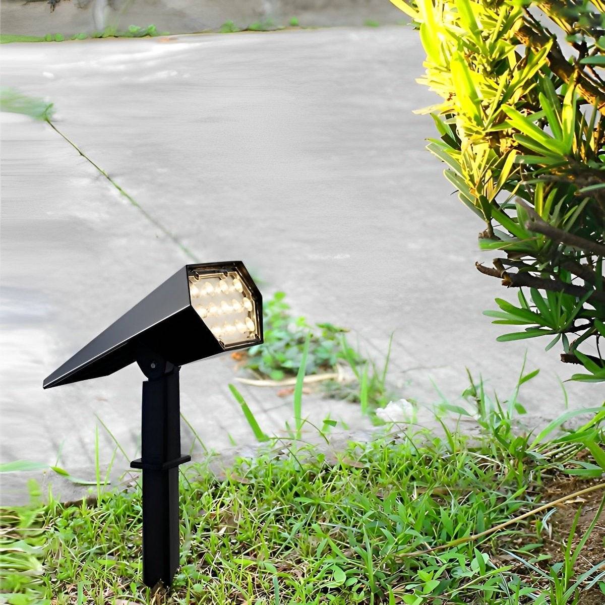 Sunpeak solar spotlight charging in daylight beside a garden path