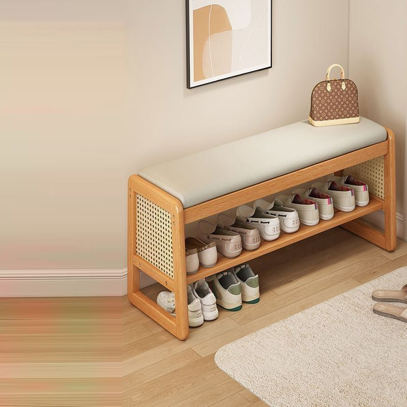 Varello rattan shoe bench in a hallway with shoes on both shelves