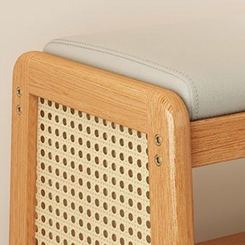 Close-up of the Varello bench's padded seat and rattan side panel