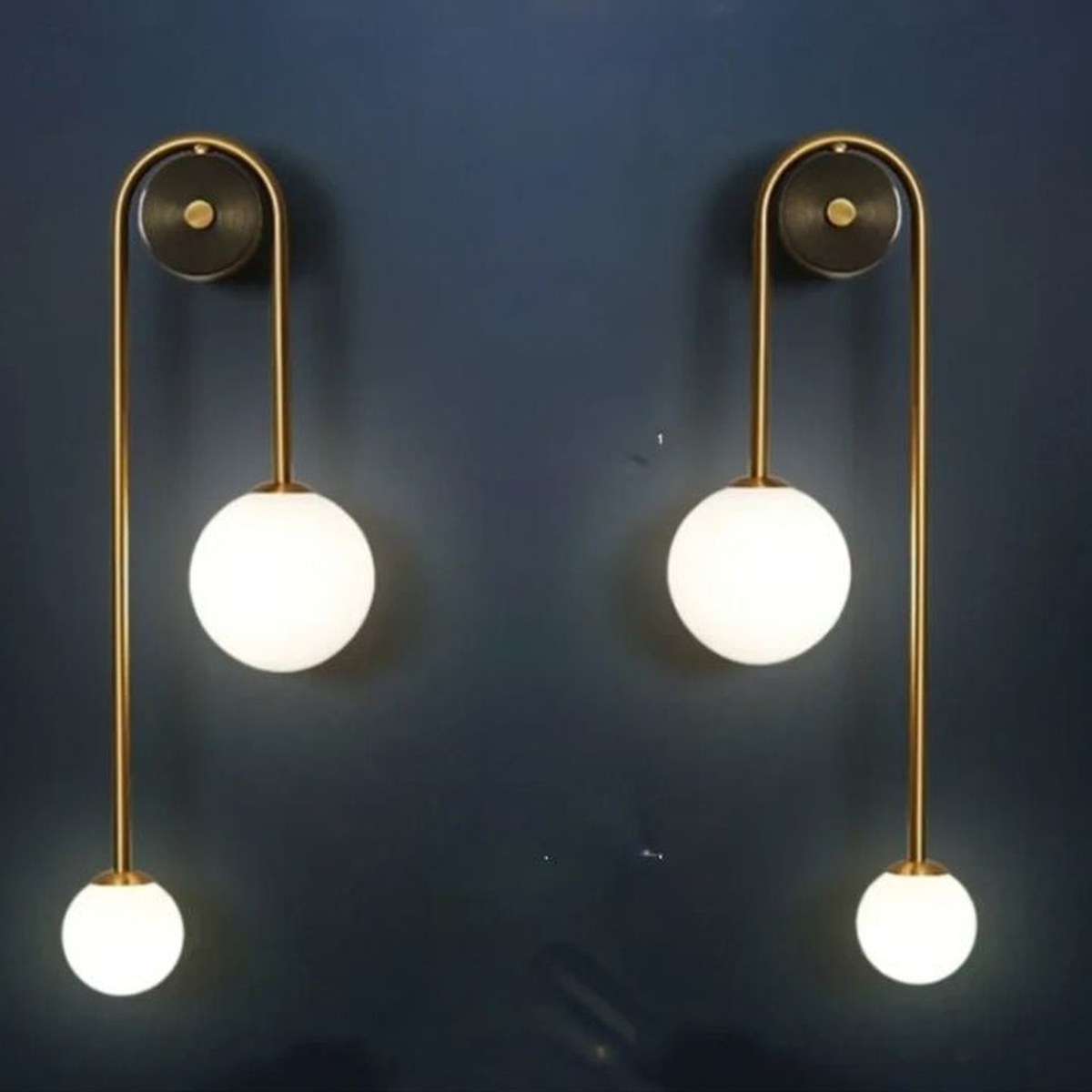 Mirrored pair of Vionessa brass wall lights with two glass globes each